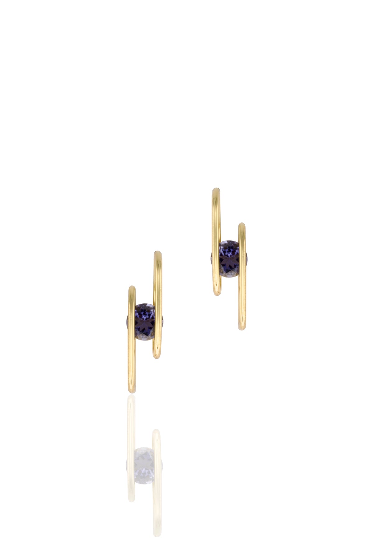 Gold earrings with navy blue gemstones on a white background