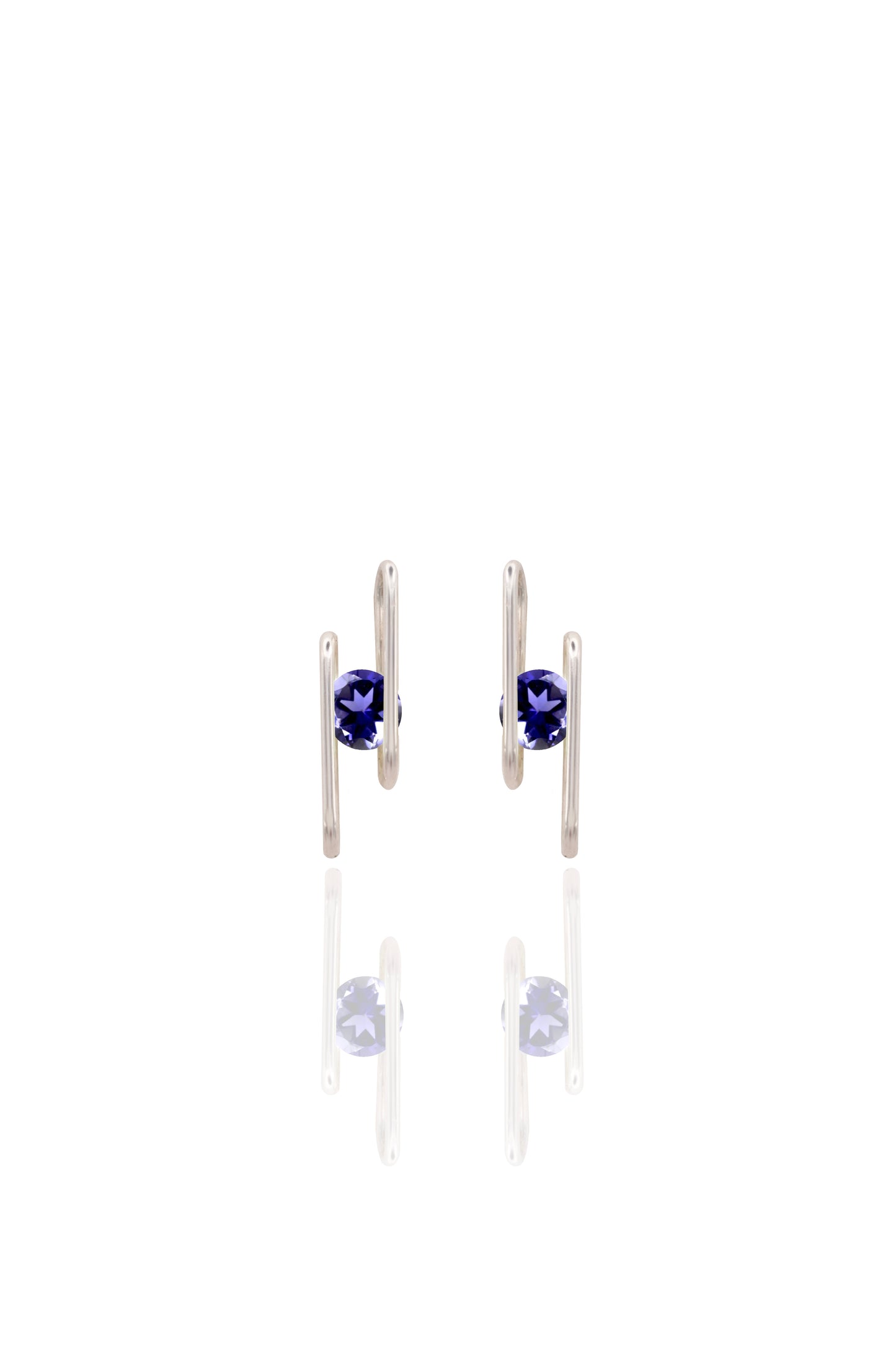 Pair of silver earrings with navy blue gemstones on a white background