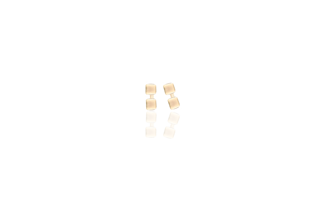 Mini 9ct yellow gold studs on white background