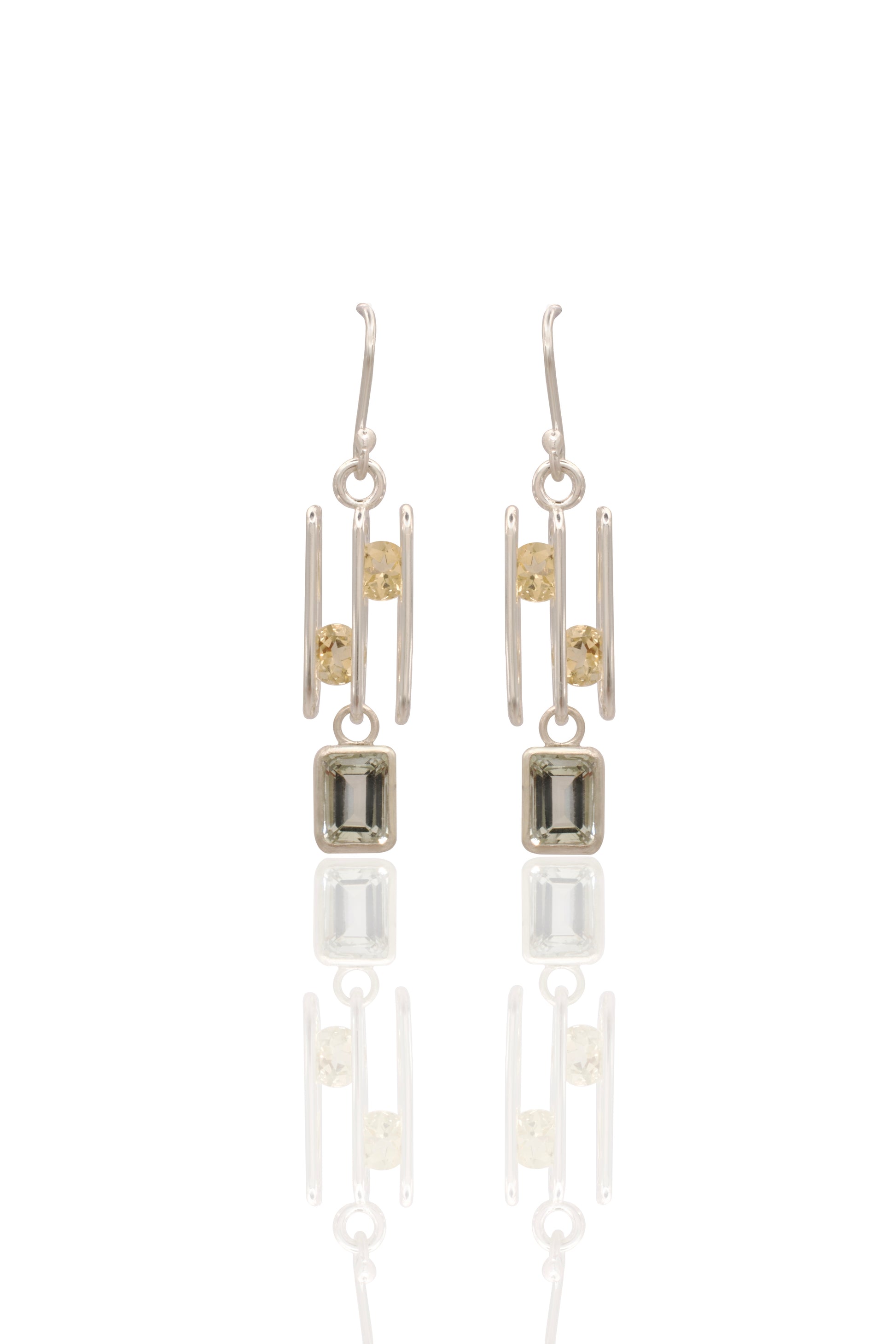 Pair of silver earrings with square stones on a white background
