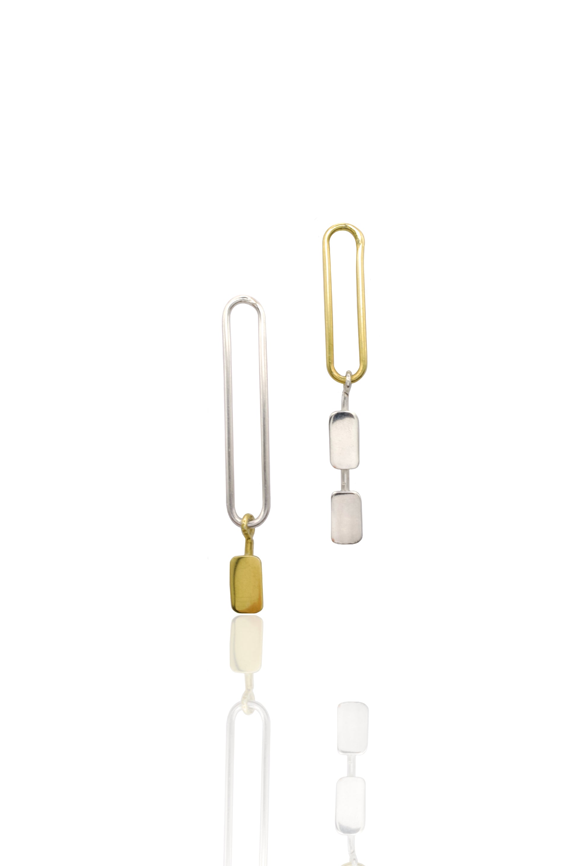 mixed metal earrings against white background 