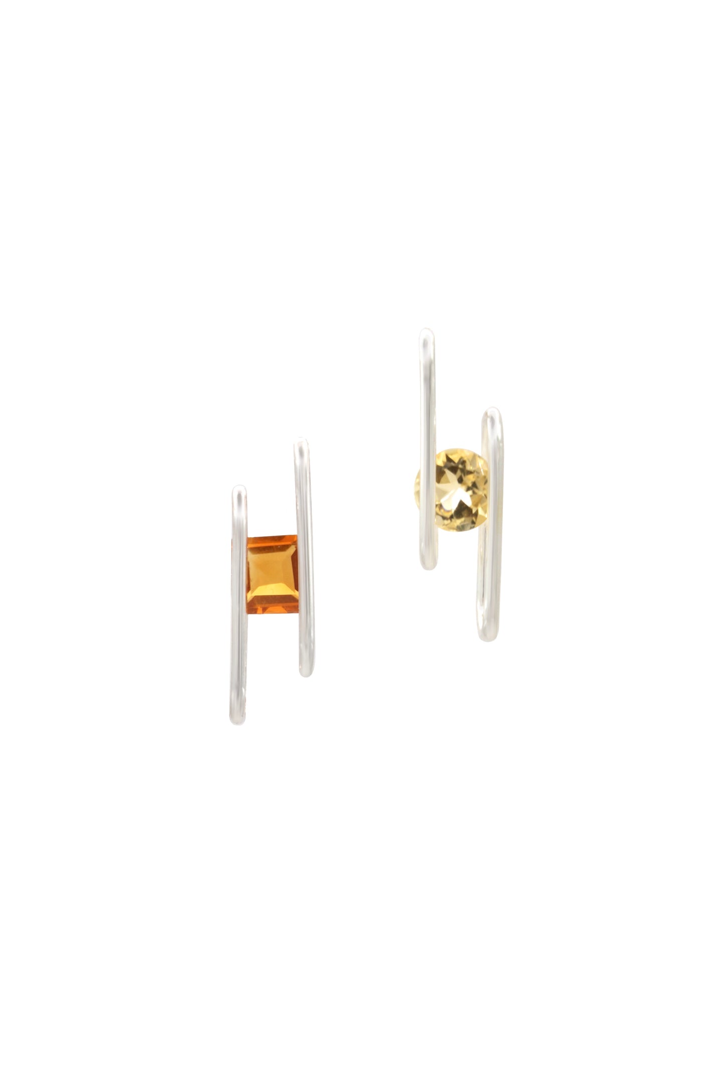 Pair of earrings with gold and silver designs on a white background