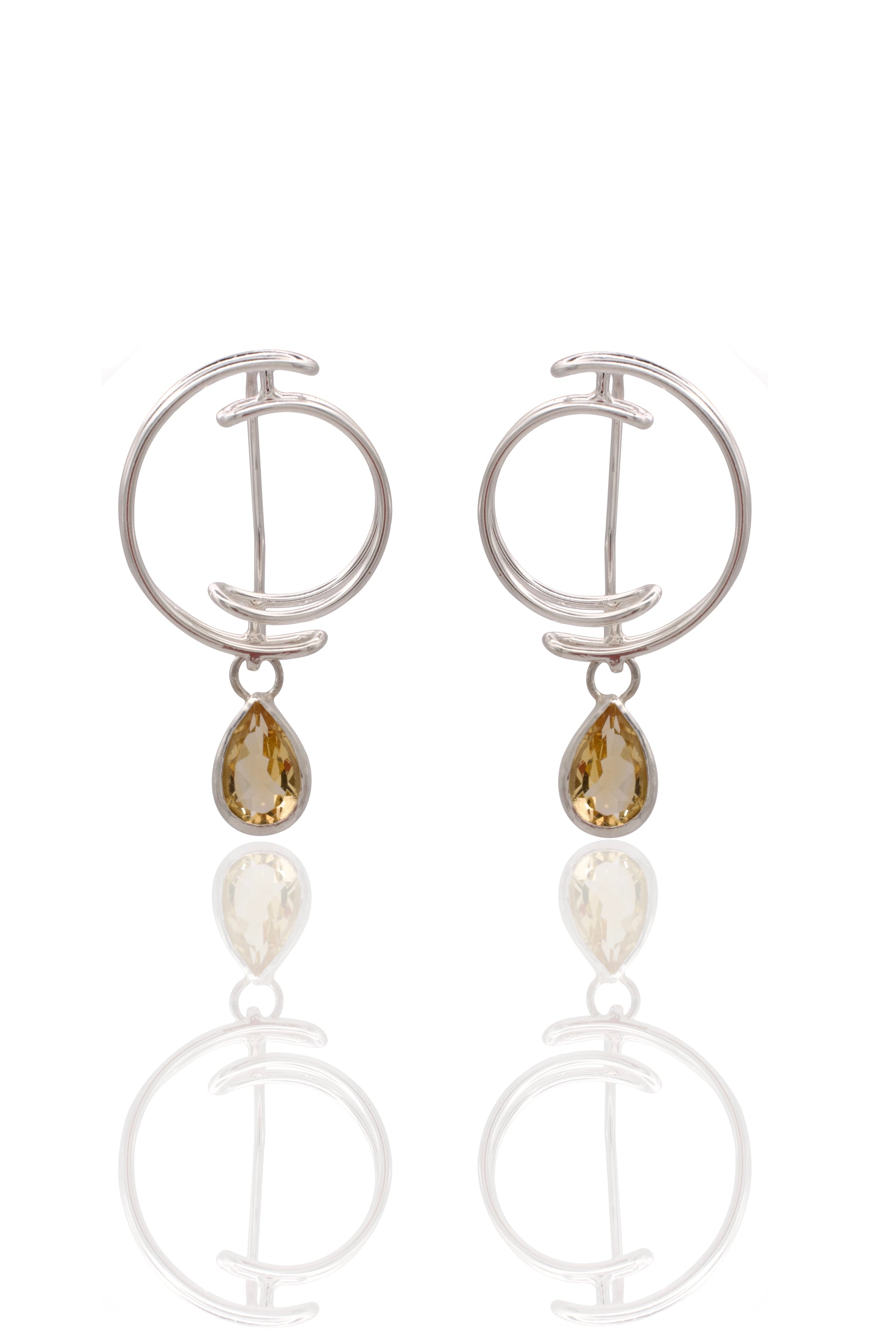Pair of silver earrings with teardrop-shaped gemstones on a white background