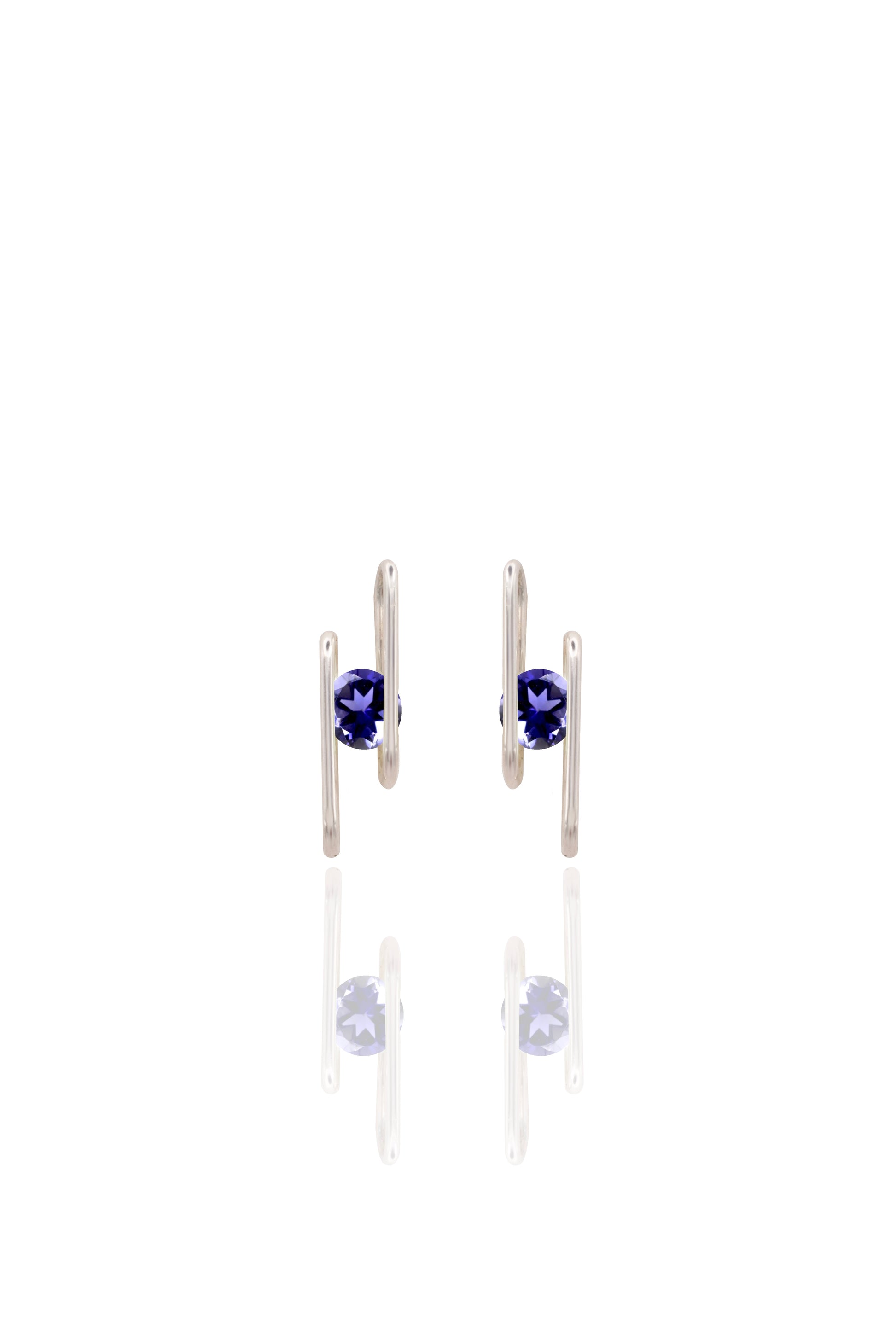 Pair of silver earrings with navy blue gemstones on a white background