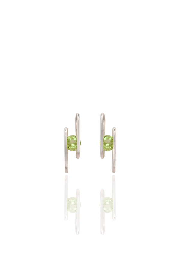 Pair of silver earrings with green gemstones on a white background