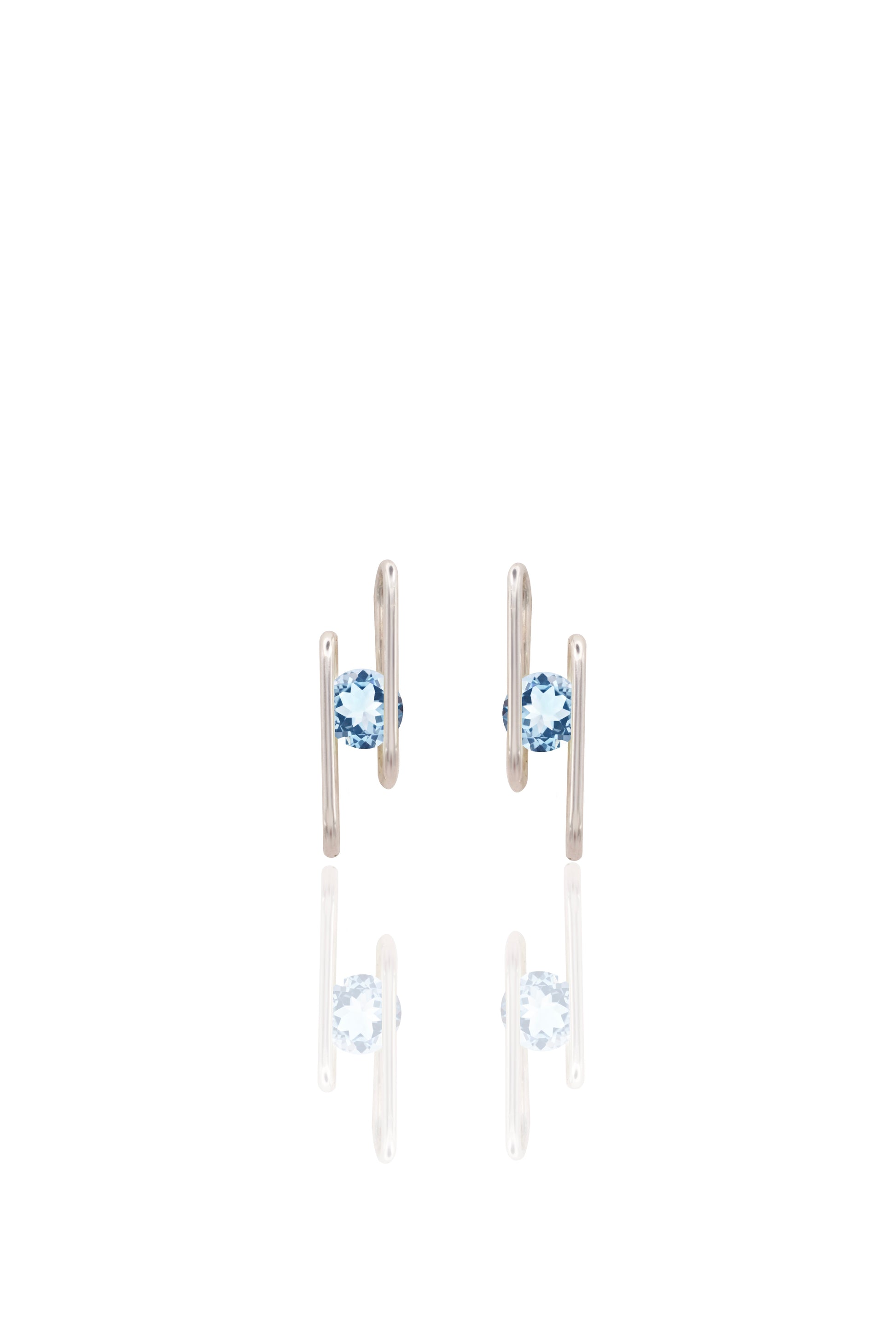 Pair of earrings with blue gemstones on a white background