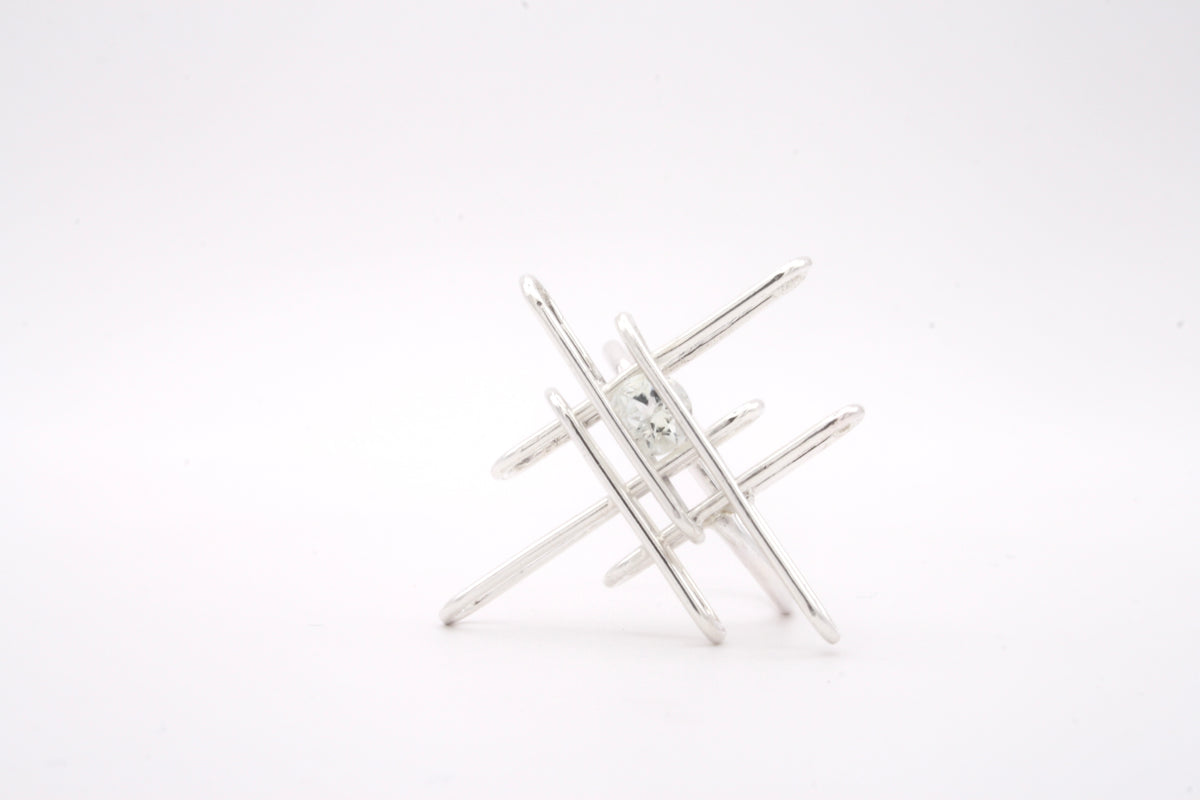 Silver geometric ringon a white background