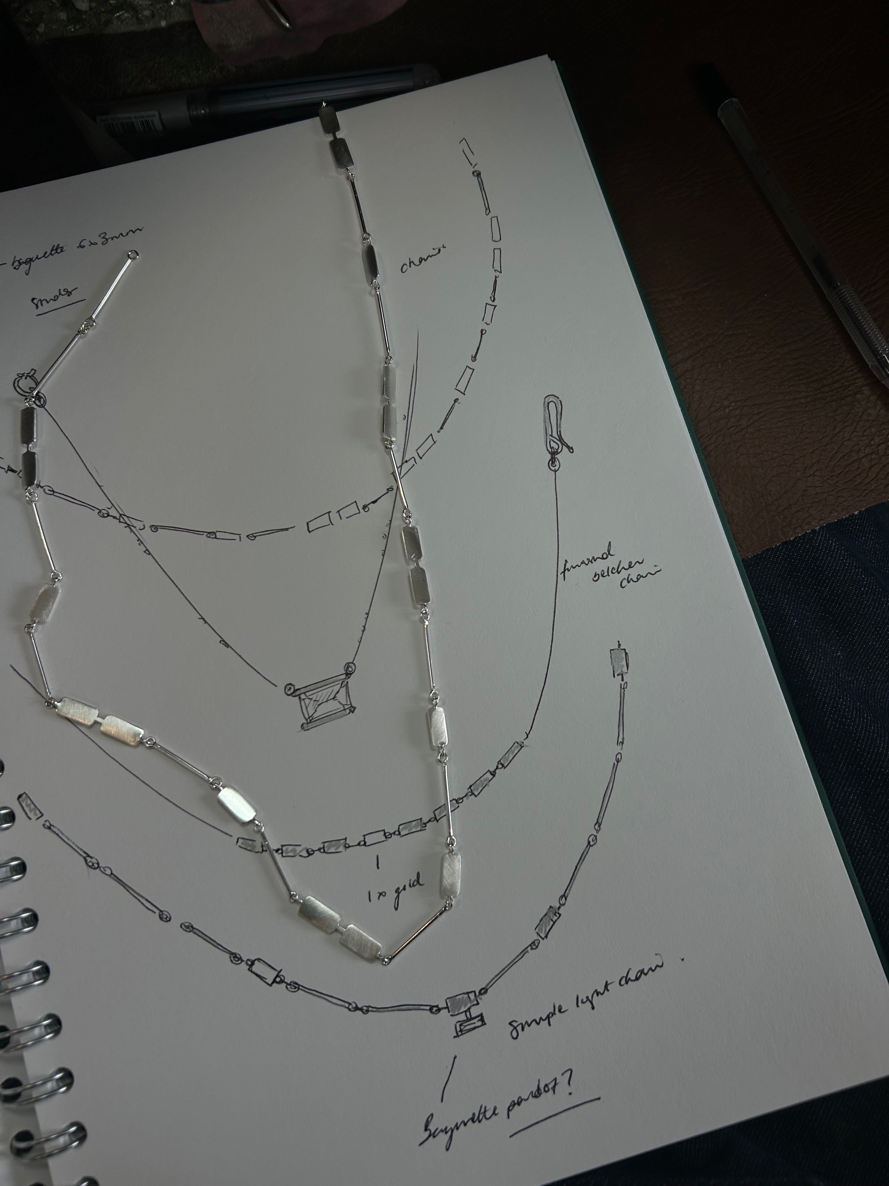 Technical drawing of a necklace on a white sheet of paper.