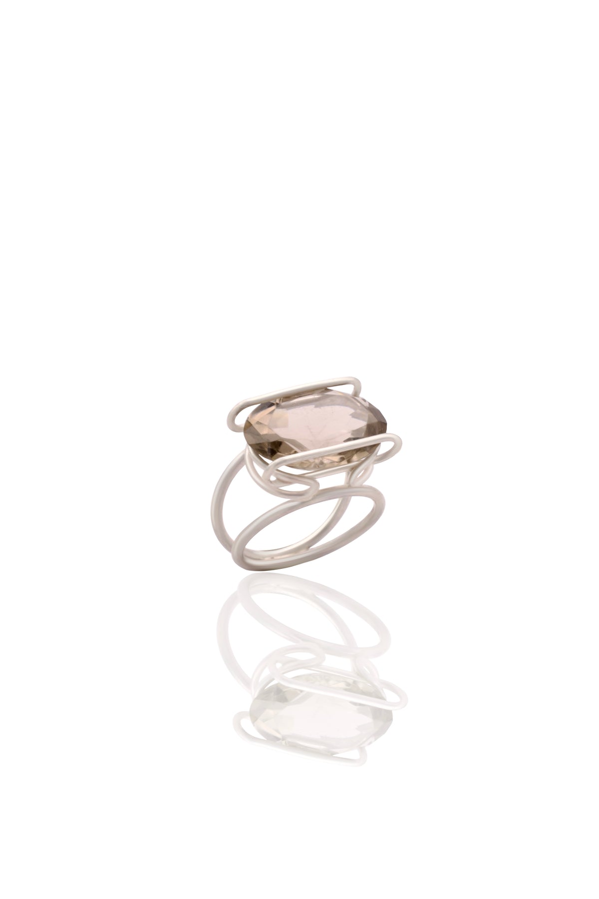 Silver ring with a clear stone on a white background