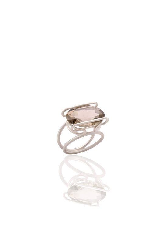 Silver ring with a clear stone on a white background